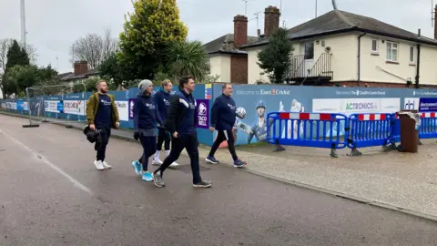 Tom Williams/BBC football fans walking