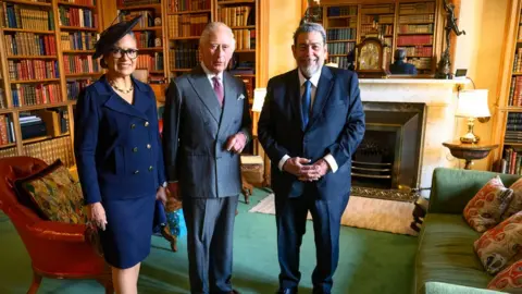 Getty Images King Charles III poses during an audience with the Prime Minister of St Vincent and the Grenadines, Ralph Gonsalves, and Mrs Eloise Gonsalves, at Balmoral Castle on October 1, 2022 in Balmoral , Aberdeen, Scotland