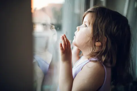 Haris Calkic / Unicef A child looks out a window at the outside world
