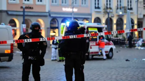 Getty Images Police officers and forensic investigators and an ambulance work at one of the scenes in Trier
