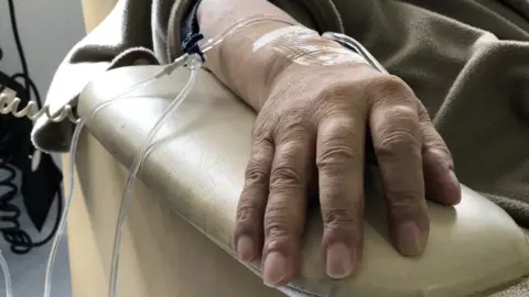 Getty Images A female patient receives chemotherapy treatment for cancer