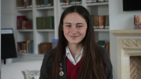 Jamie Niblock/BBC School pupil Isabel sitting in school library