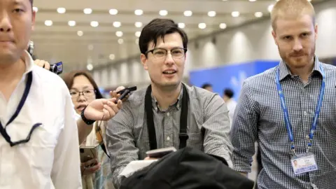 Reuters Alek Sigley at the airport