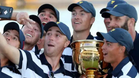 Justin Thomas with Jordan Spieth and Rickie Fowler with the Presidents Cup after being part of the winning US team in 2017
