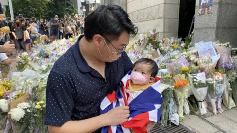 A father and his seven-month-old daughter wrapped in a union jack