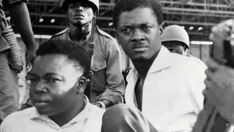 AFP A picture taken in December 1960, shows soldiers guarding Patrice Lumumba (R), Prime Minister of then Congo-Kinshasa, and Joseph Okito (L), vice-president of the Senate, upon their arrest in Leopoldville (now Kinshasa)