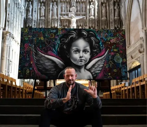 Phil Gelb Ant Steel signing with his hands “God, I love you” with his hands after his first workshop at the cathedral