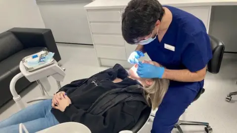 BBC A patient being treated in the dental clinic