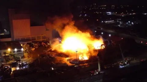 Merseyside Fire and Rescue Service Aerial shot of fire at scrap yard