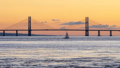 Getty Images A sailboat passes alongside the Prince of Wales Bridge