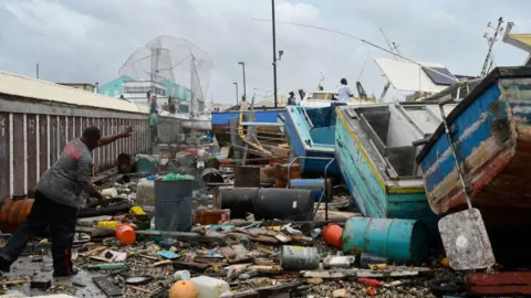 Getty Images Damaged fishing boats pile up against each other after Hurricane Beryl at the Bridgetown Fish Market, Bridgetown, Barbados, July 1, 2024. 