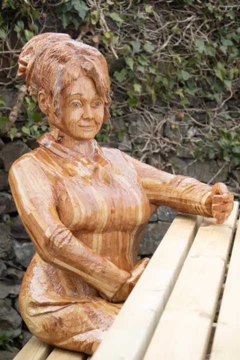 D&G Woodlands A closer up image of the sculpture of a wooden woman