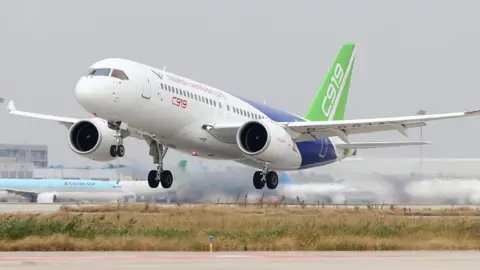 Getty Images Comac C919, China's first large passenger jet, takes off from Pudong International Airport in Shanghai on 10 November 2017