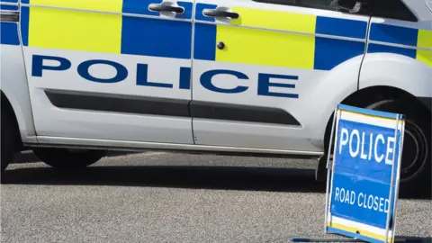 Getty Images Stock photo police car and sign