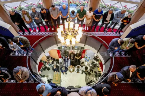 Robin Utrecht/AFP People pray as they attend an early morning prayer on Eid al-Adha, at the Mevlana Mosque in Rotterdam, Netherlands