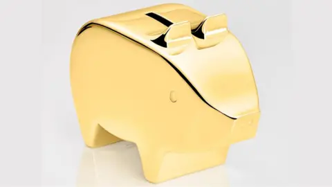 PA Media Artists impression of the £100,000 gold piggy bank