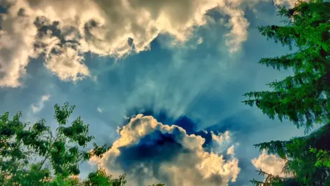 Tim Turan The sun behind a cloud over Cowley on Father's Day