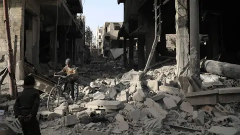 AFP Destroyed buildings in Douma, in the Eastern Ghouta region of Syria (19 March 2018)