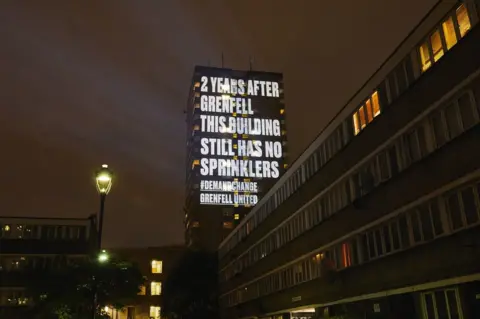 Grenfell United / PA A message is projected onto a building in London