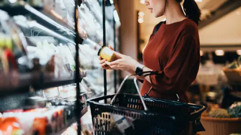 Getty Images Woman checking food price