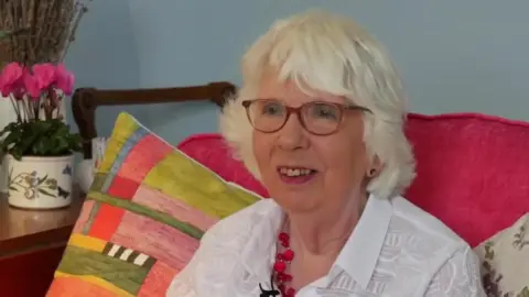 BBC Plymouth Hoe resident Sue Dunn sat on a pink armchair with two cushions behind her