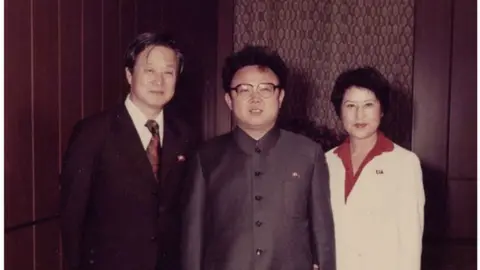 BBC / Hellflower films / Shin Films Foundation Screenshot from "North Korean Kidnap - The Lovers and the Despot" showing Shin, Kim and Choi (L to R)