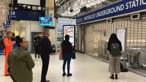 BBC Passengers look at closed gates