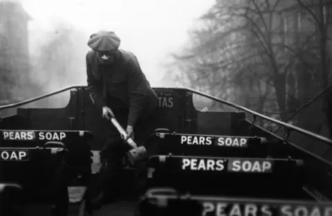 Davis/Hulton Archive/Getty Images The top deck of a bus is sprayed in the hope of reducing infection