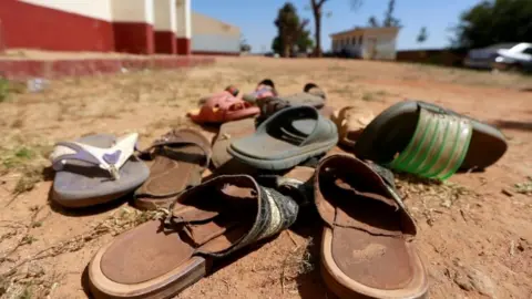 Reuters Sandals sit in the dirt following an attack on a Nigerian school