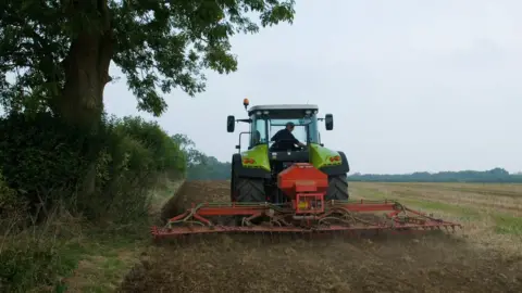Getty Images A farmer driving a tractor