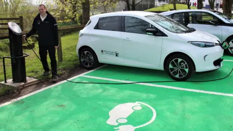 Brecon Beacons National Park Authority Kevin Booker, IT Systems and Fleet Officer, charging one of the park's electric vehicles