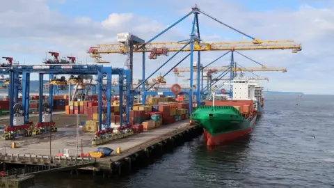 Michael Cooper/Getty Images A cargo ship unloading at Belfast Port (archive image)