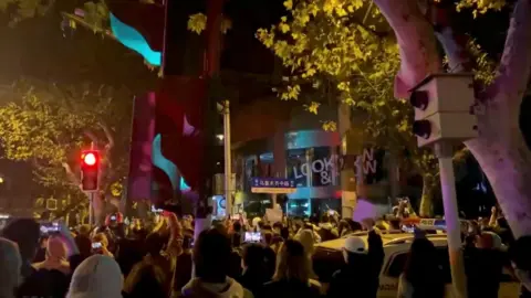 VIDEO OBTAINED BY REUTERS A still of the protest in Shanghai on Sunday