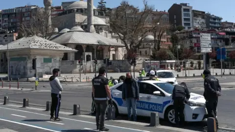 EPA Turkish police fine some people who violate the two-day curfew during lockdown in Istanbul, Turkey, 12 April 2020