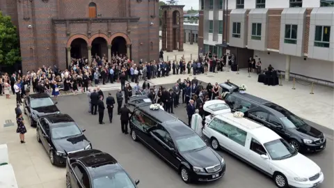 EPA Family and friends at the funeral of Lars, Vivian and Annabelle Falkholt