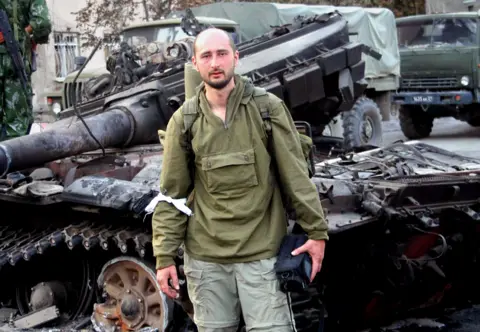 Getty Images Arkady Babchenko posing in front of Georgian Army tank wreckage in Tskhinvali, South Ossetia - 2008