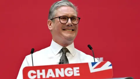 Getty Images Keir Starmer stands at red lectern reading "change"