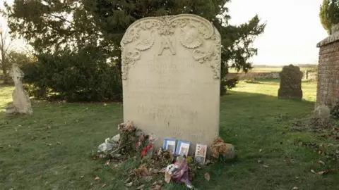 At Agatha Christie's grave in Cholsey. There are flowers and books left at the gravestone.