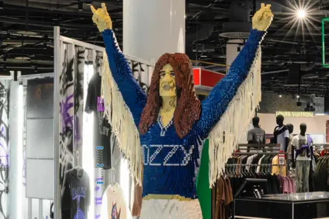 David Parry Photography A giant figure of Black Sabbath's Ozzy Osbourne made of bricks stands inside a Selfridges store, surrounded by clothes rails
