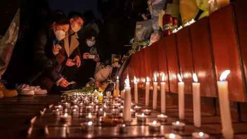 Protesters light candles in Beijing