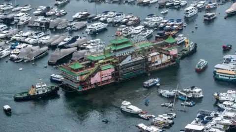 Getty Images The famous Jumbo Floating Restaurant is towed away by tugboats after 46 years as a much-loved tourist attraction in Aberdeen, Hong Kong.