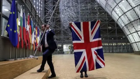 Reuters Officials remove the British flag at European Union Council in Brussels