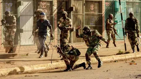 AFP A soldier fires shots towards demonstrators, on August 1 2018, in Harare, as protests erupted over alleged fraud in the country's election.