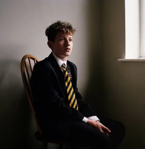 Harry Borden A school boy sitting on a chair