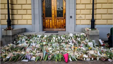 Getty Images Flowers lay outside the secondary school as a memorial