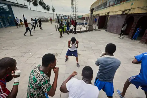 Hugh Kinsella Cunningham Group training within the walls of the Stade Tata Raphael