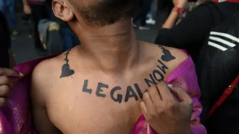 Getty Images Member and supporter of the lesbian, gay, bisexual, transgender and queer (LGBTQ) community flaunts his body art at New Delhi's Queer Pride Parade in India