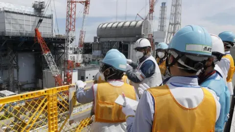 AFP/Getty Images Journalists pictured at the Fukushima nuclear power plant