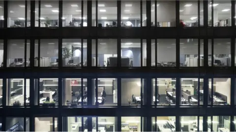 Getty Images People working in an office block