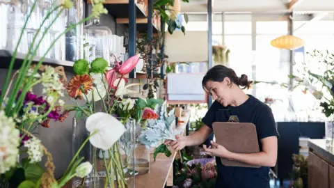 Getty Images A woman working in a flourist